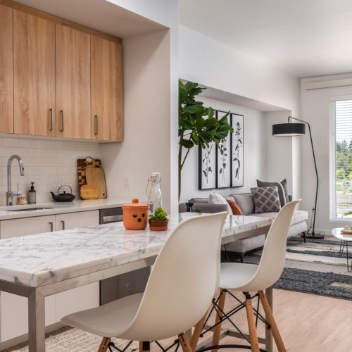 a kitchen with a dining table and chairs